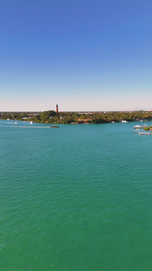 Boat passing in front of the Jupiter Lighthouse.